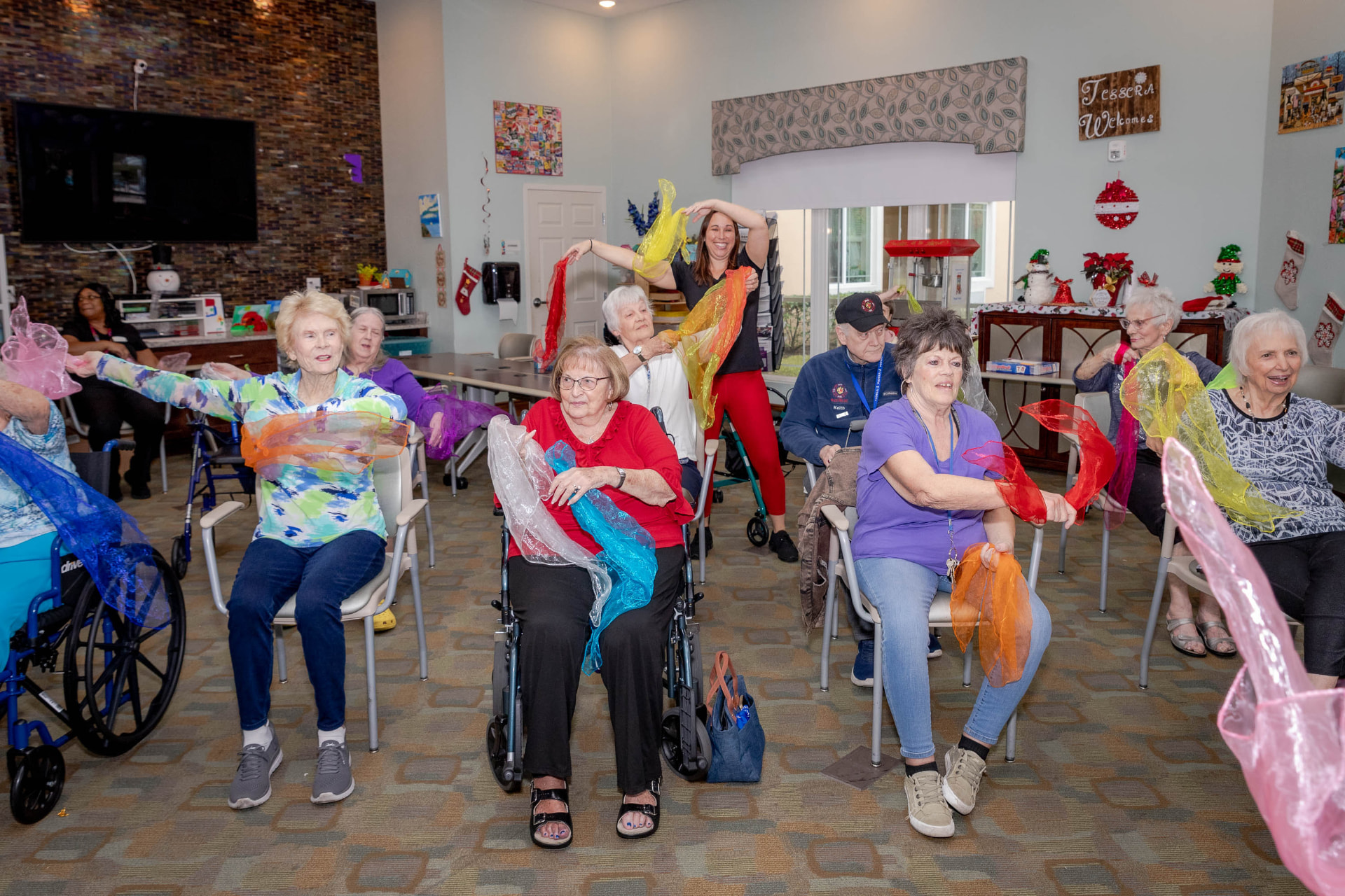 Seated participants flowing with colorful scarves