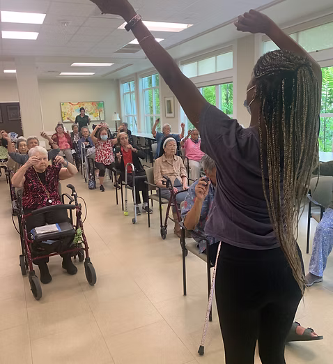 A participant shaking bells to the beat